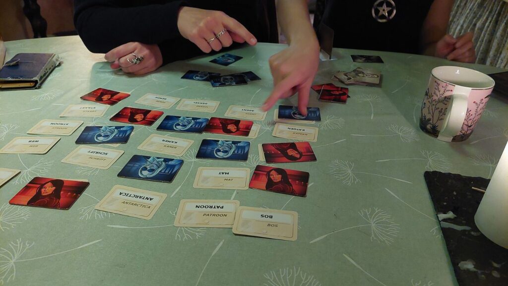 Friends playing Codenames around a table