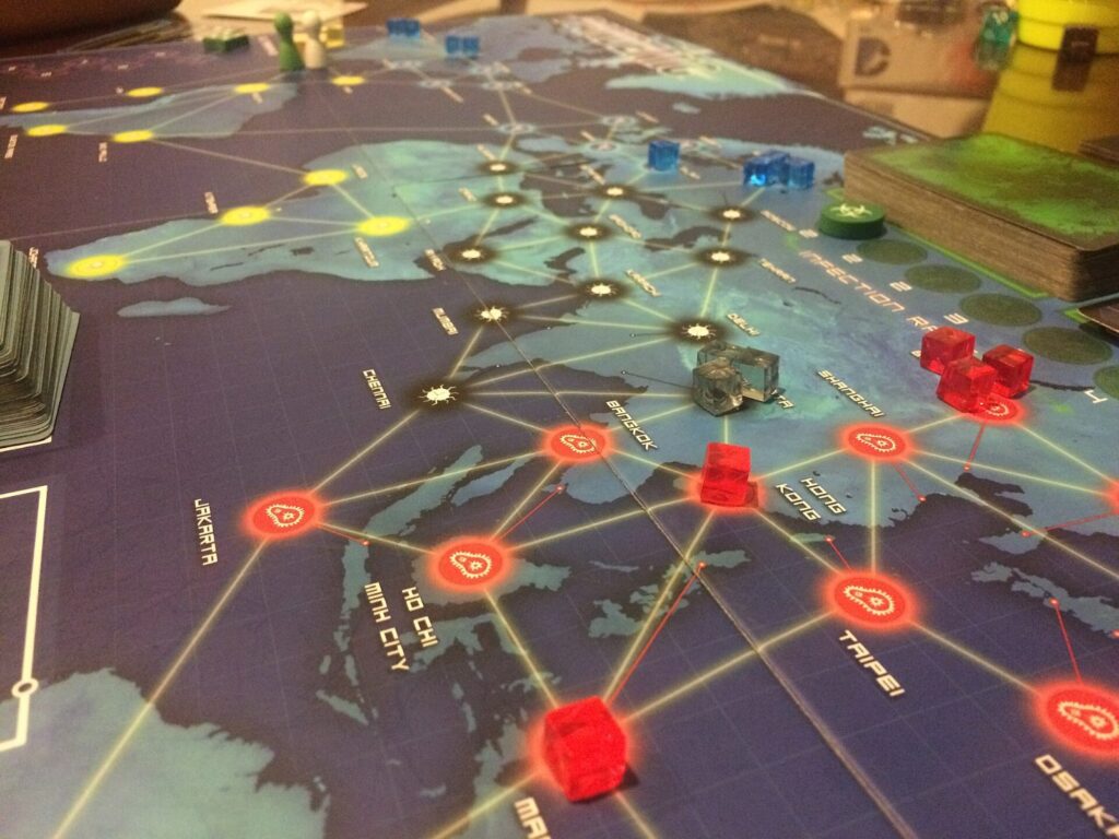 The Pandemic world map board with disease cubes