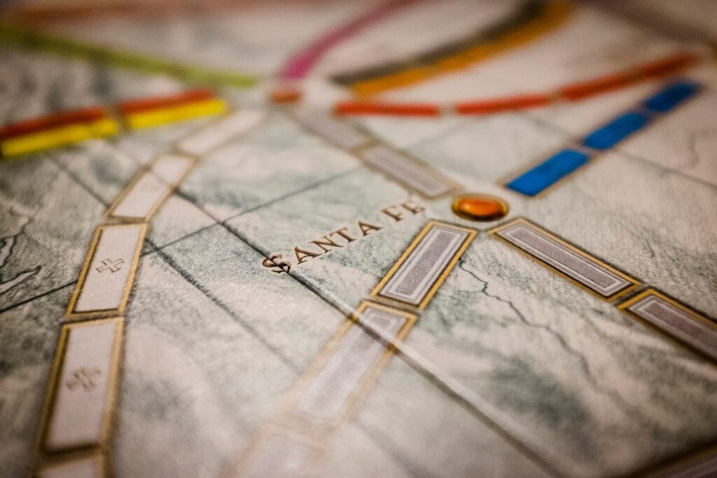 A Ticket to Ride board with coloured trains on the map